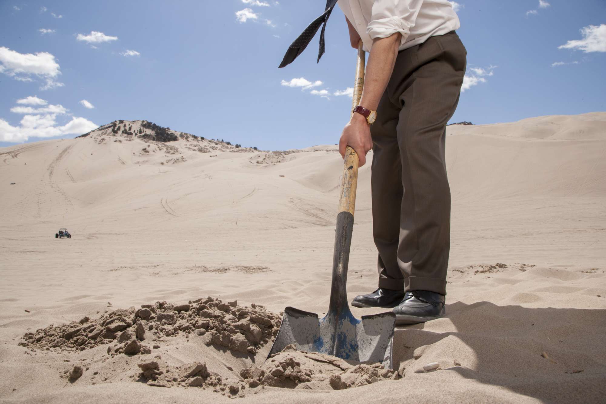 Digging на русском. Человек копает. Лопата в песке. Копает песок. Пустыня лопата.